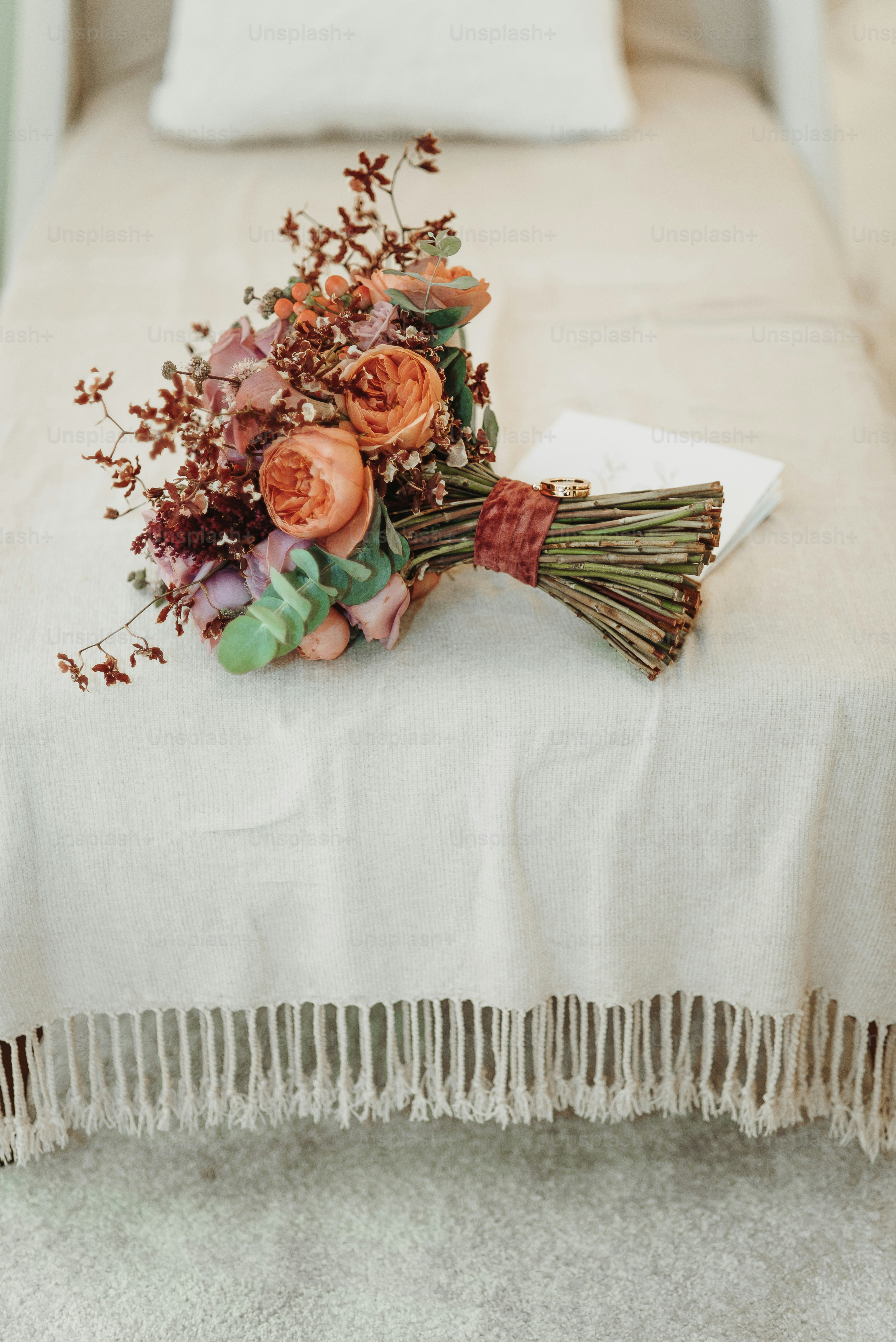 a bouquet of flowers sitting on top of a bed