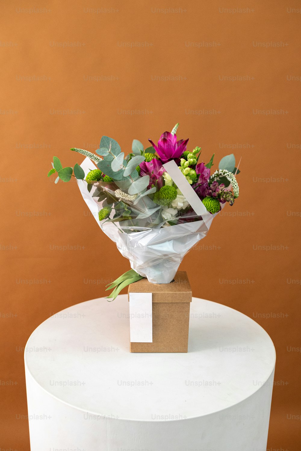 a bouquet of flowers sitting on top of a white cake