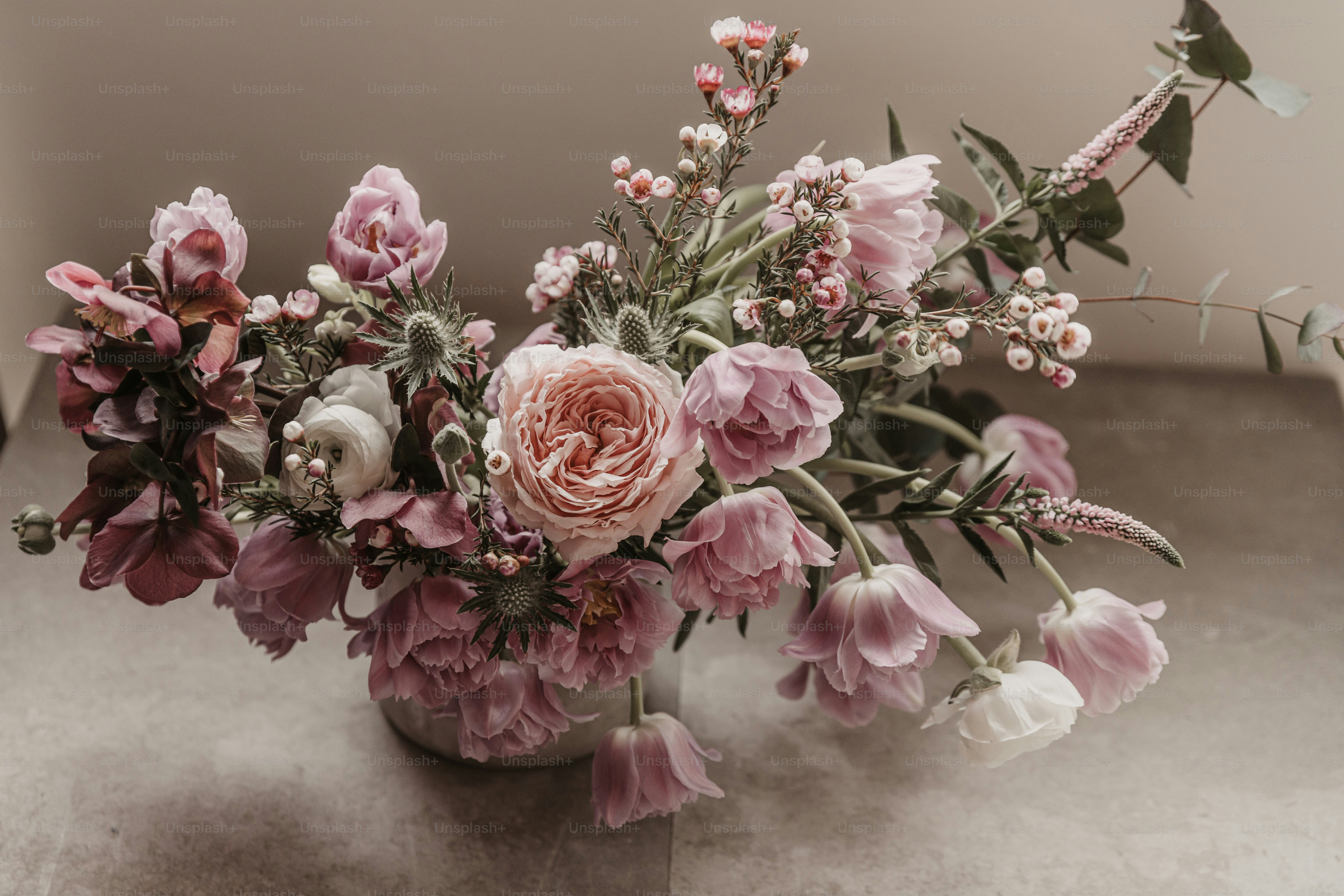 a vase filled with lots of pink and white flowers