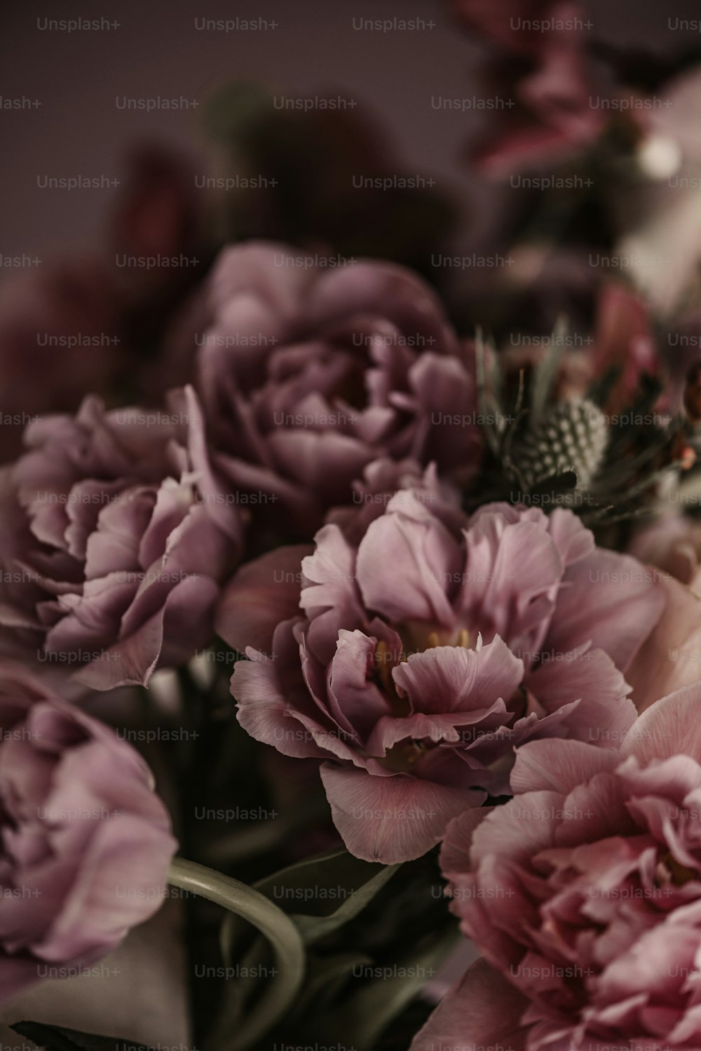 a bouquet of pink flowers sitting on top of a table