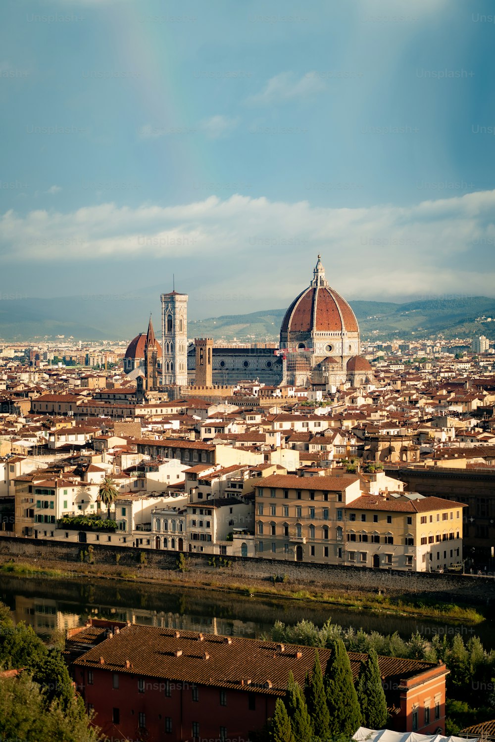 a view of a city with a rainbow in the sky