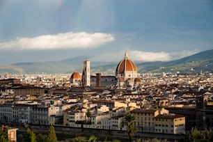 a view of a city with a rainbow in the sky