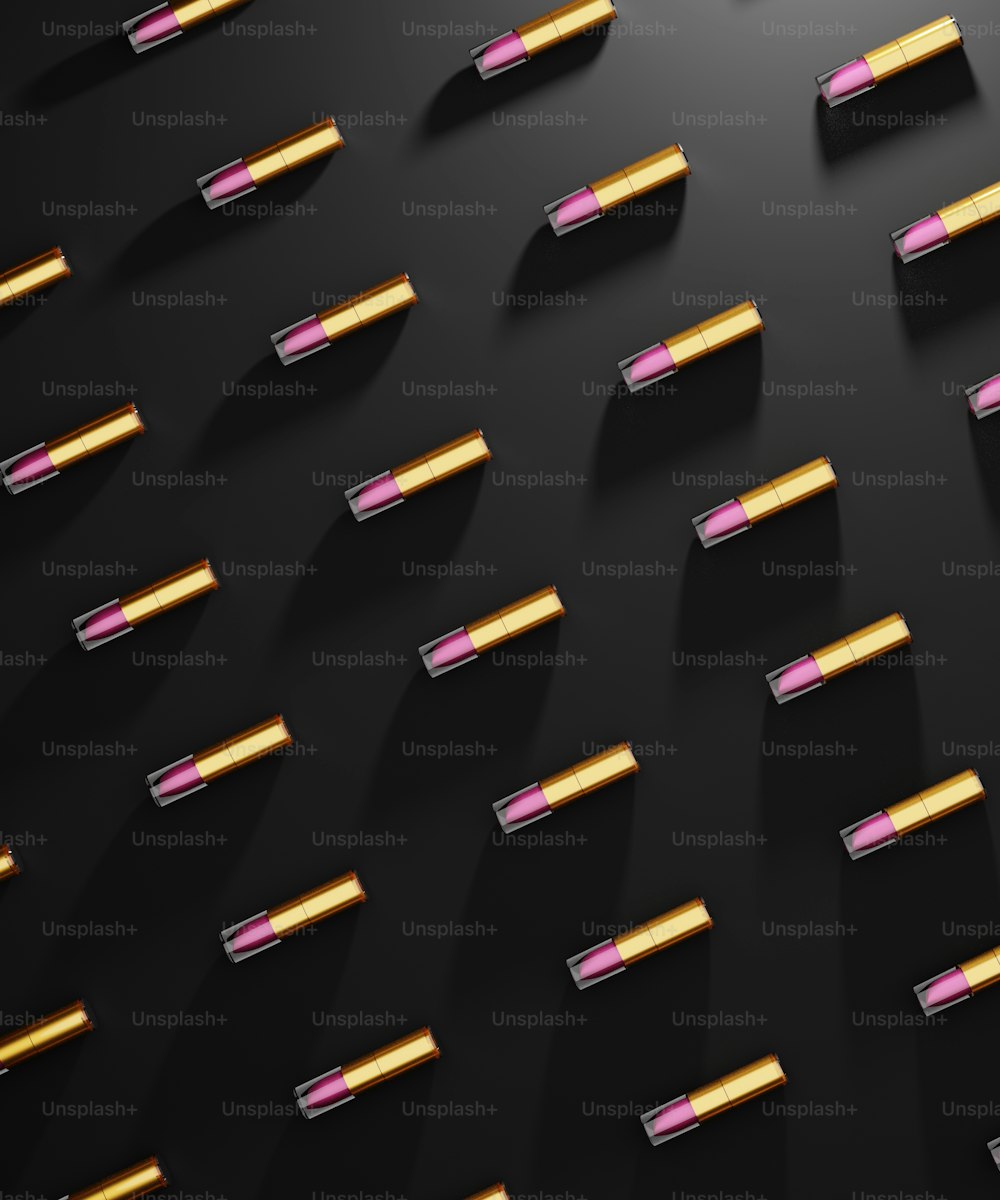 a group of lipsticks that are on a black surface