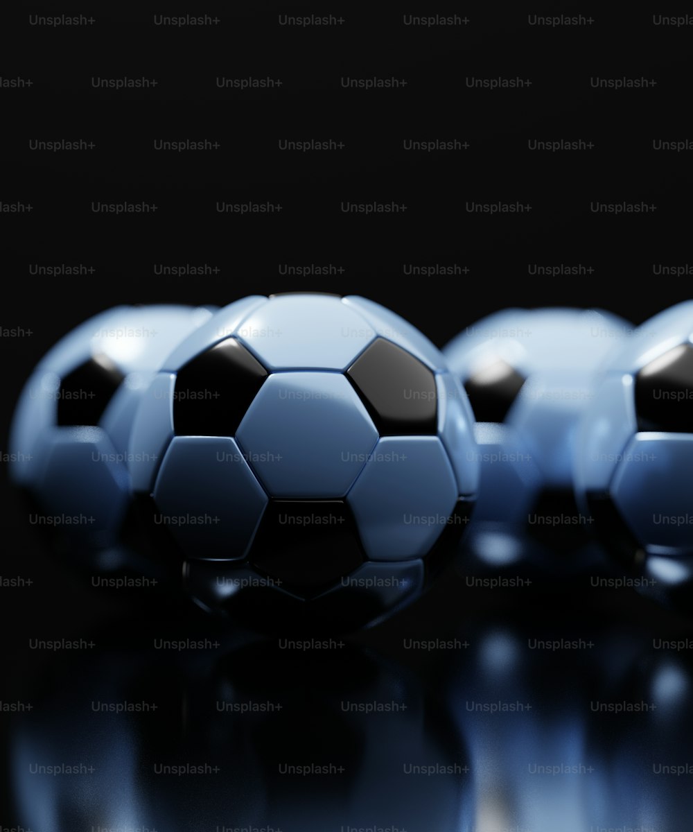 a group of three soccer balls sitting on top of a table