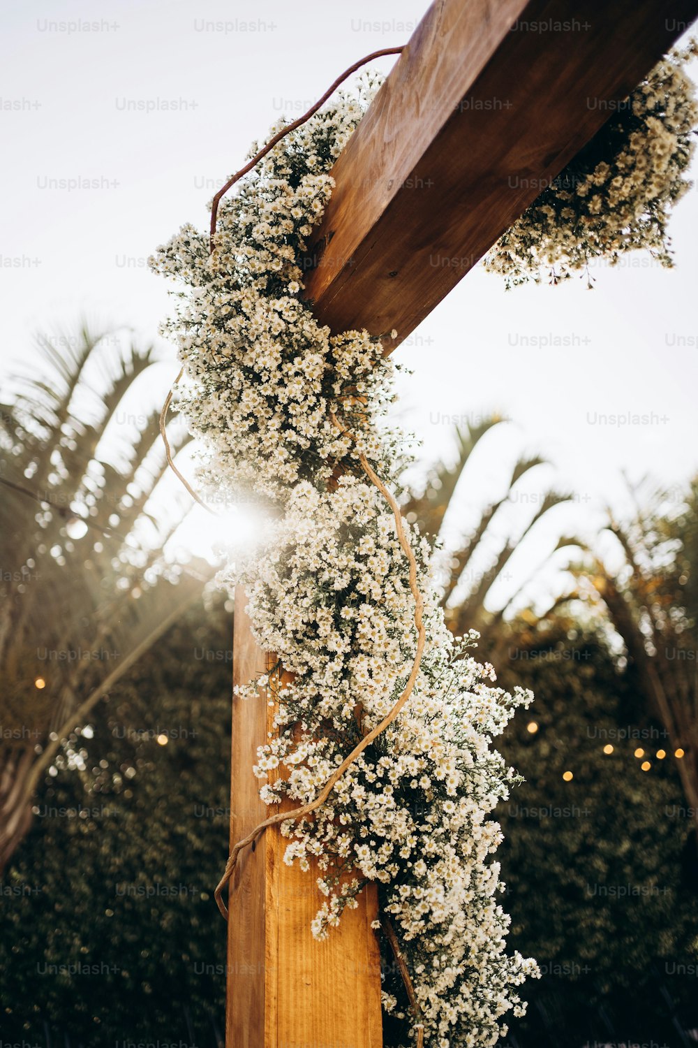 a wooden pole with a bunch of flowers on it