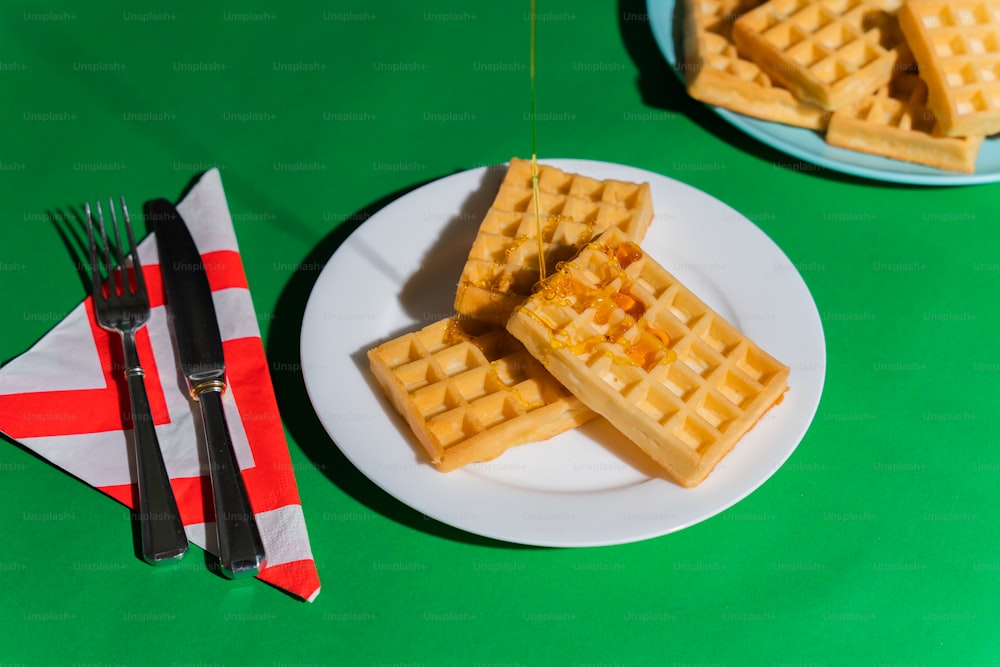 a plate of waffles on a green table