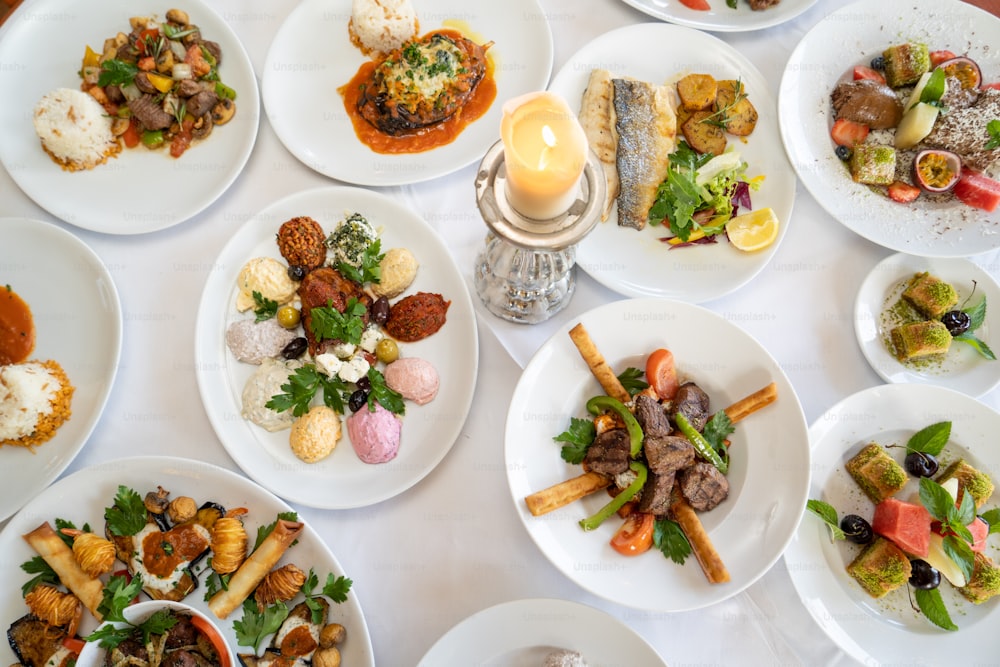 a table topped with lots of plates of food