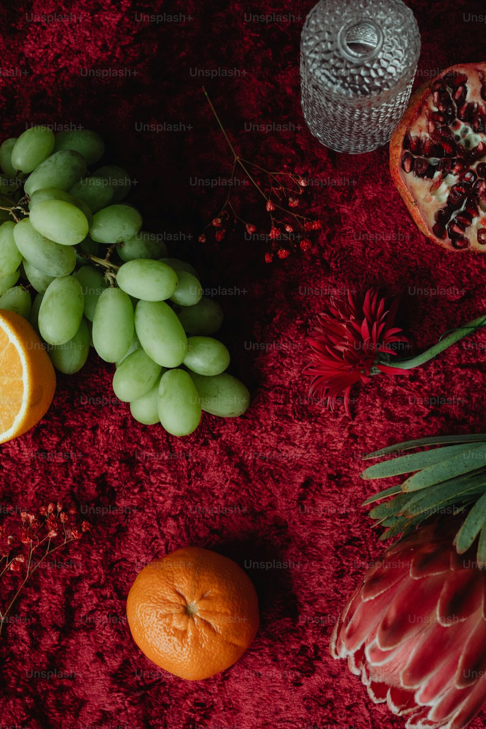 a variety of fruits are arranged on a red surface