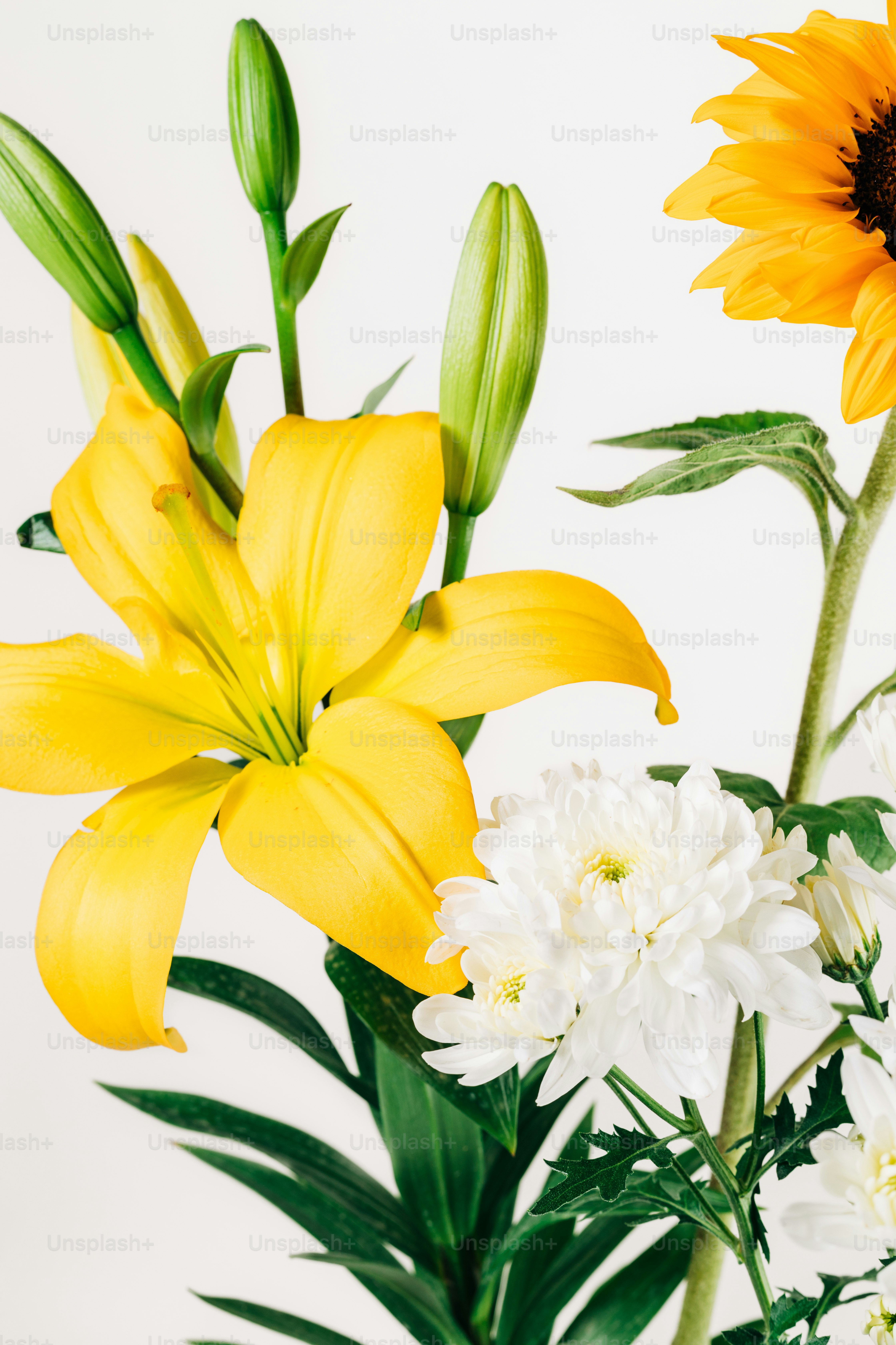 a vase filled with yellow and white flowers