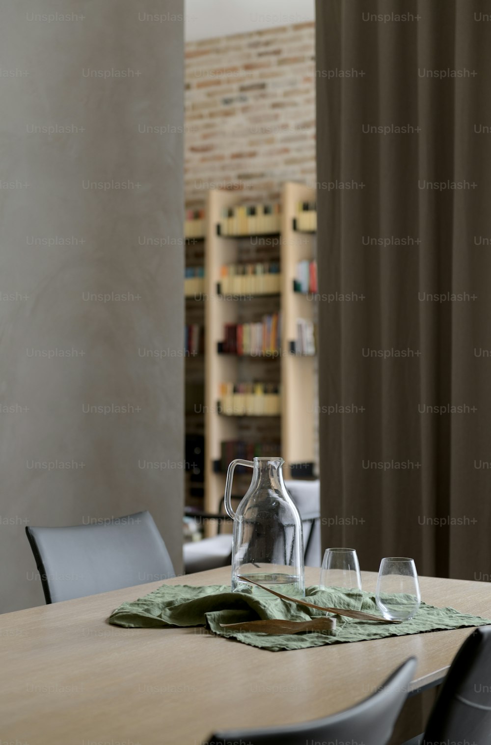a wooden table topped with a bottle of wine