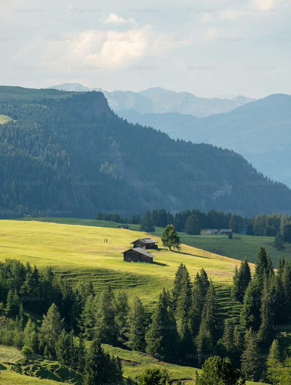 a large field with a house in the middle of it