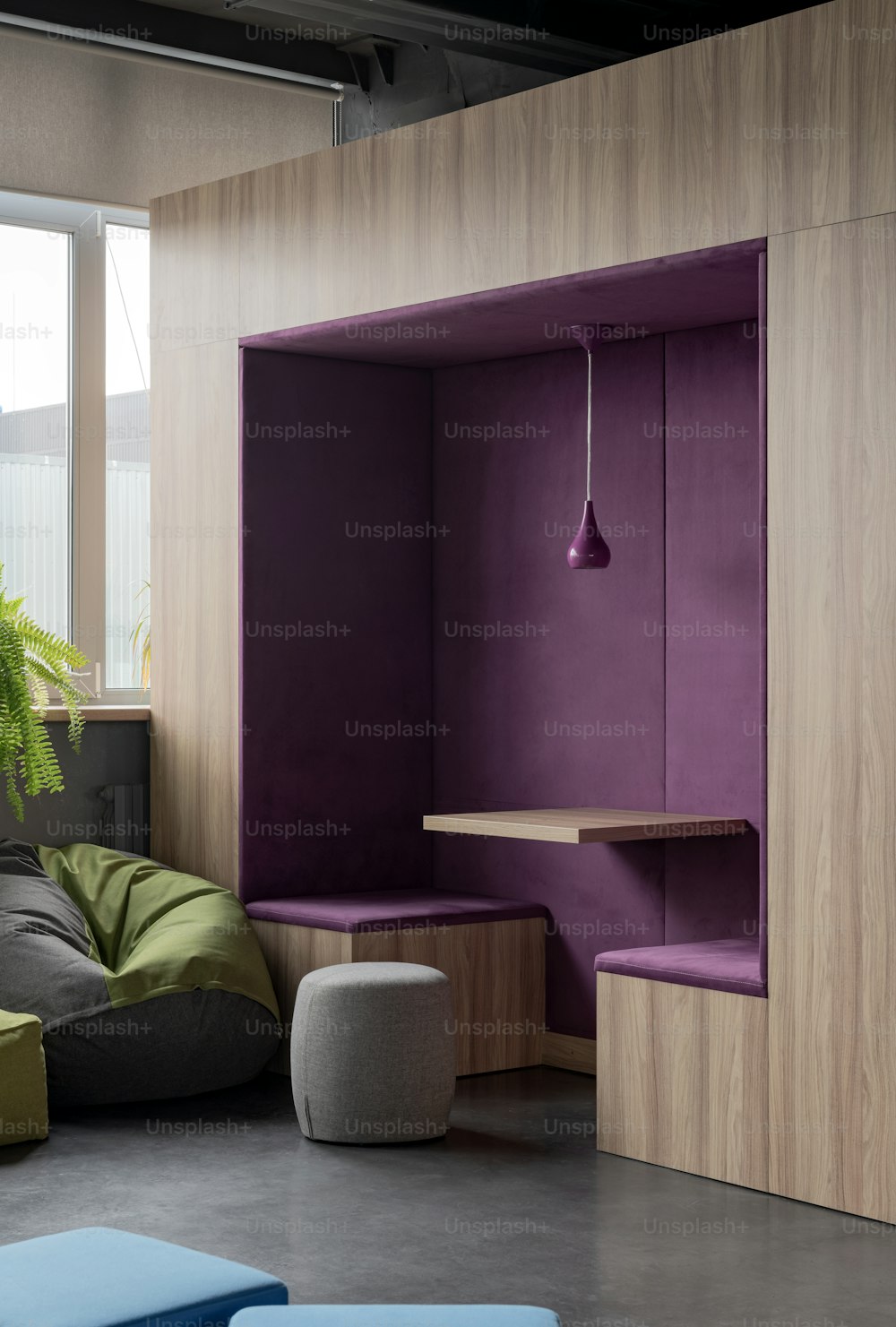 a living room with purple walls and furniture