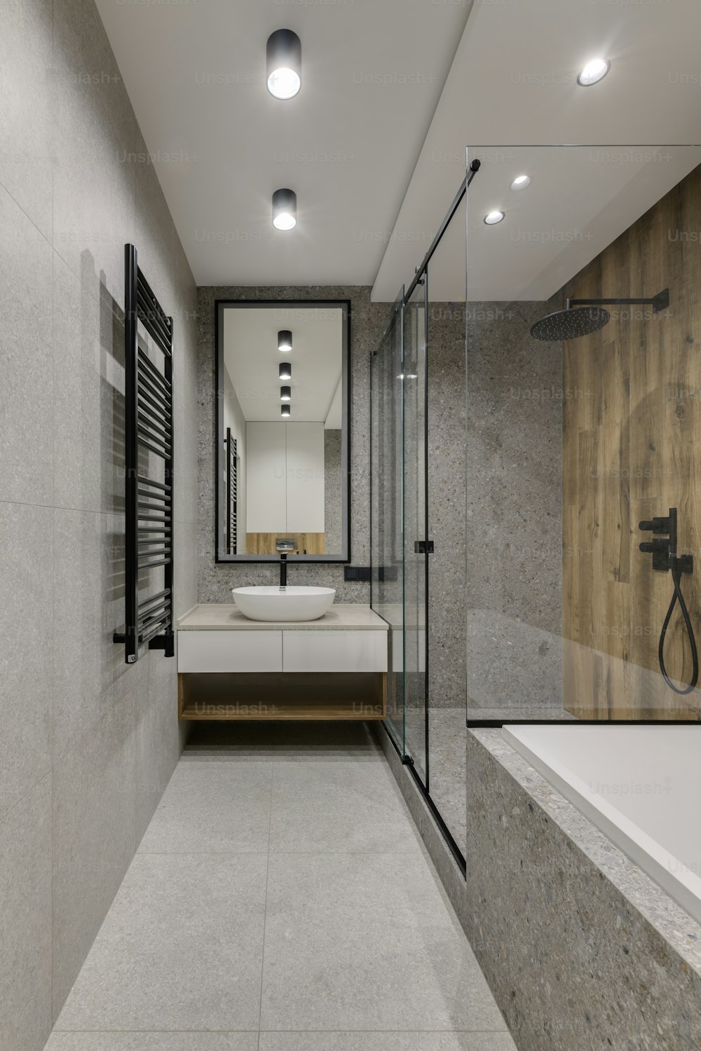 a bathroom with a tub, sink, and mirror