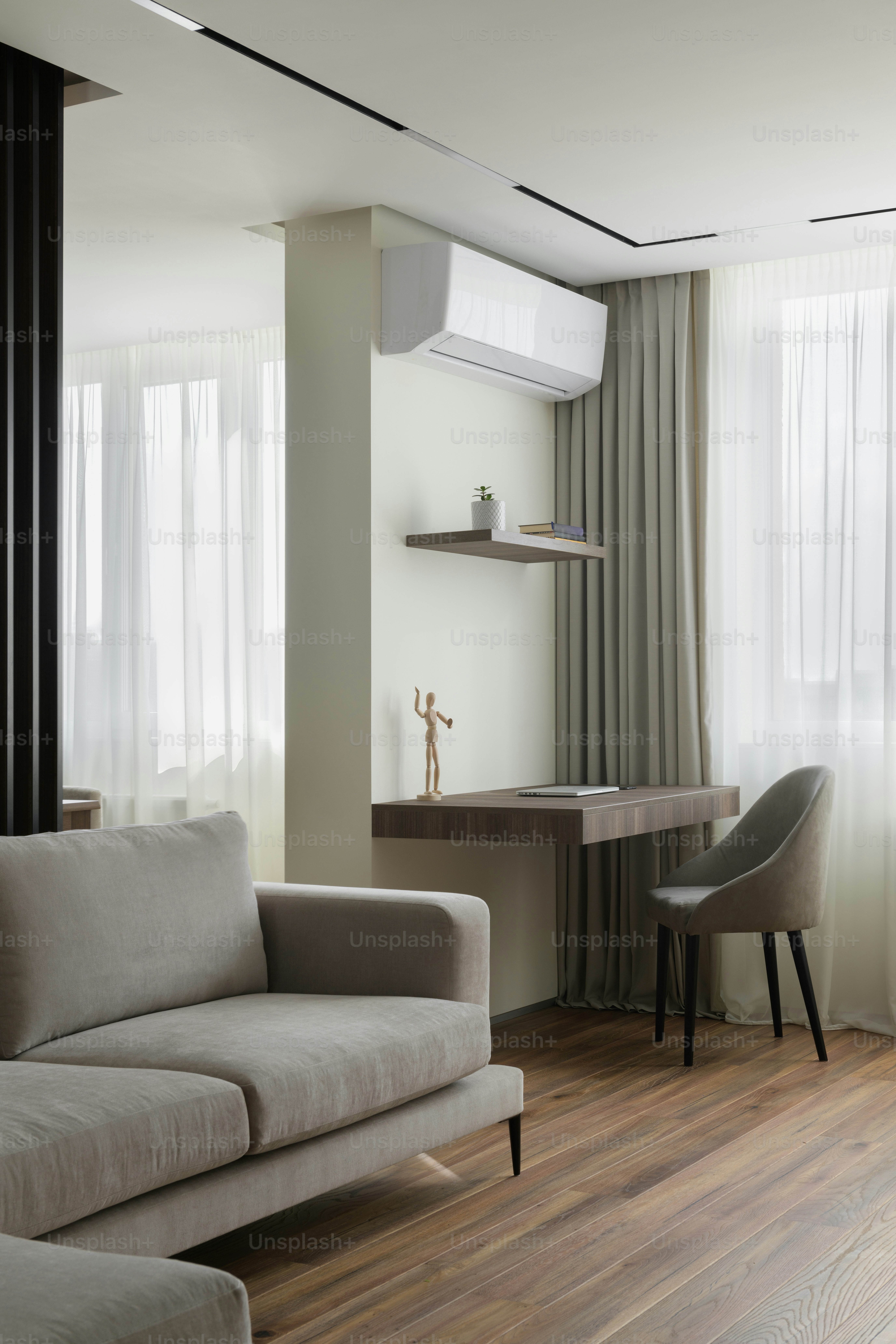 a living room with a couch a chair and a desk