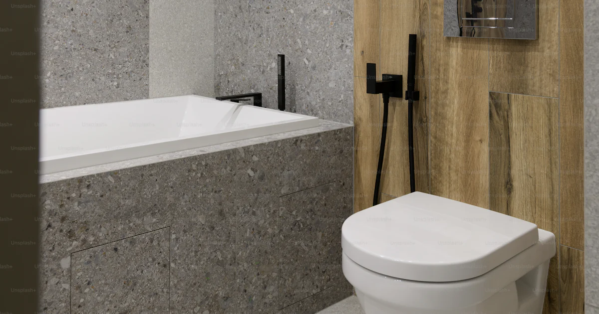 A white toilet sitting next to a white bath tub photo – Interior design ...