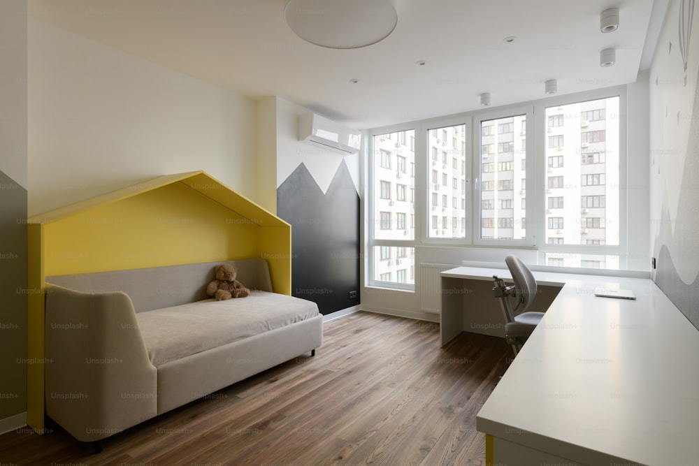 a living room with a couch and a desk