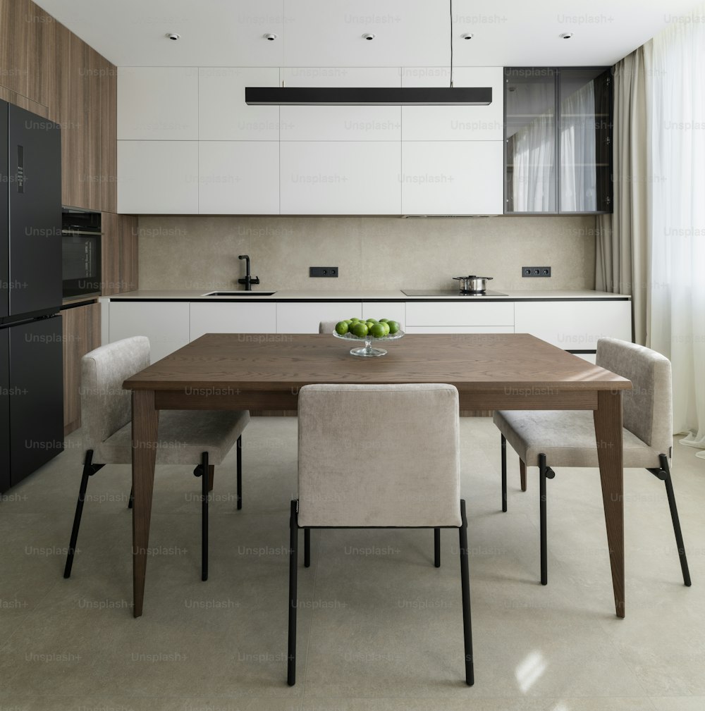 a kitchen with a table and chairs and a refrigerator