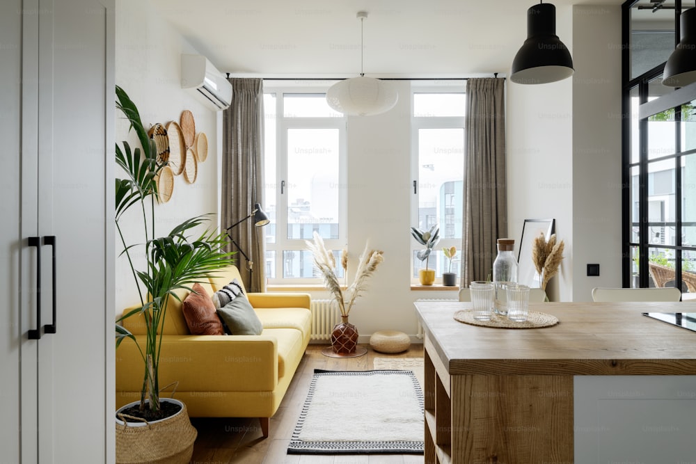 a living room filled with furniture and a large window