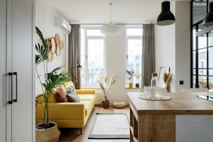 a living room filled with furniture and a large window