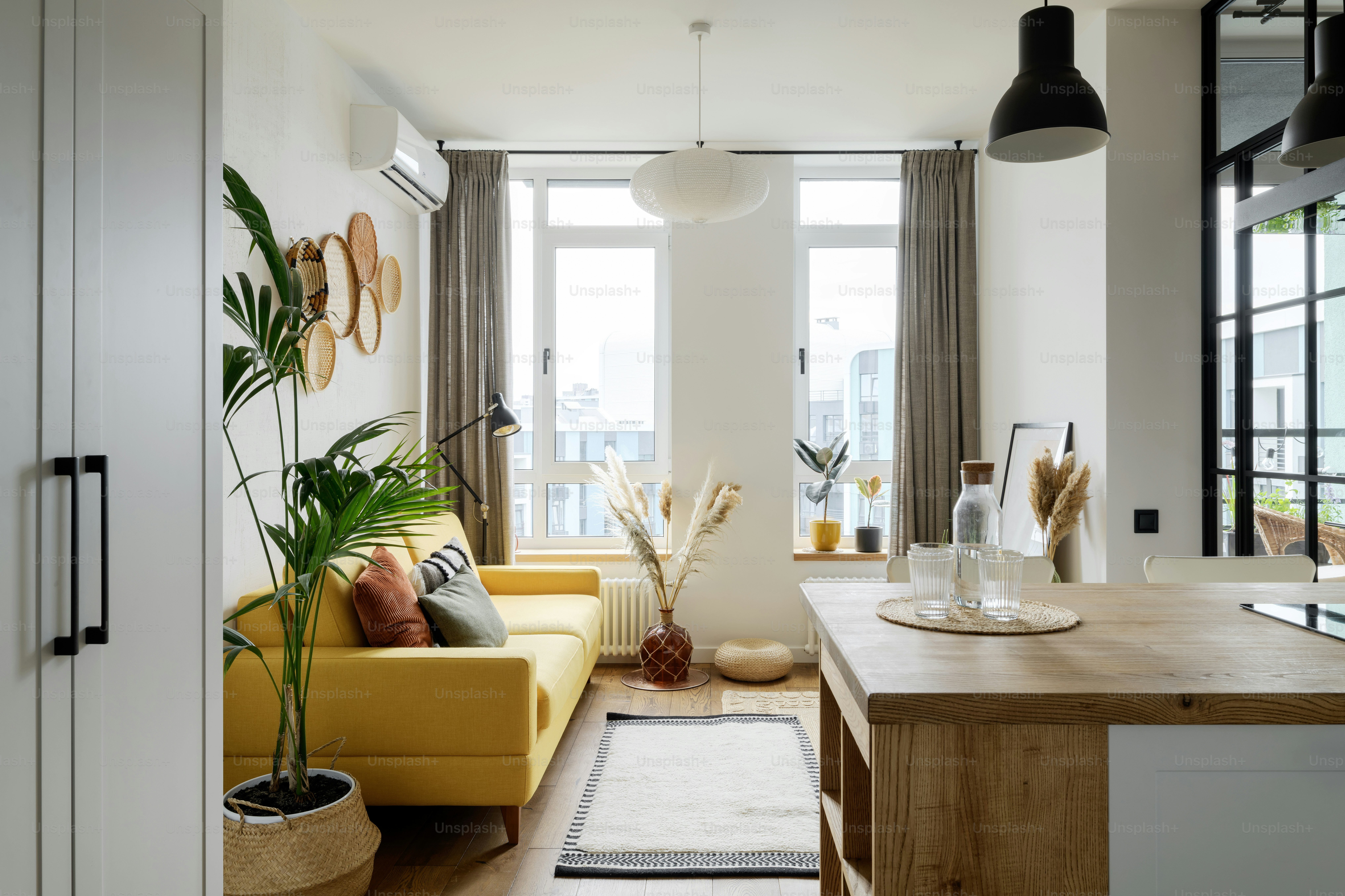 a living room filled with furniture and a large window