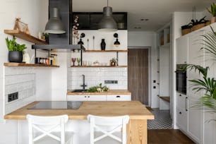 a kitchen with a wooden table and white chairs