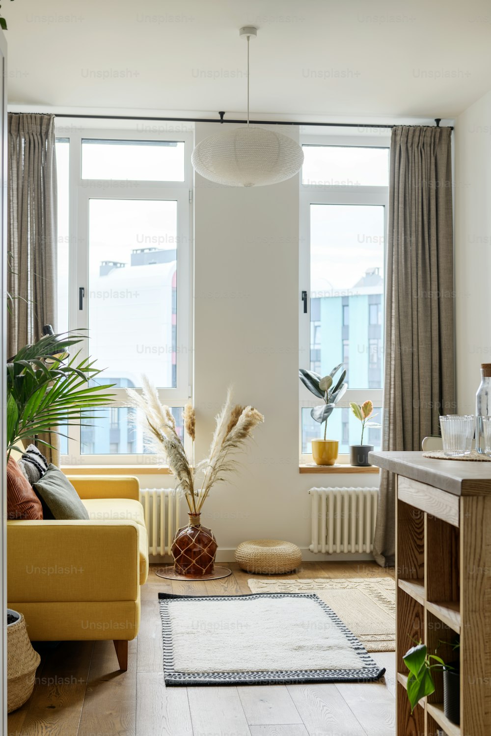 a living room filled with furniture and a large window