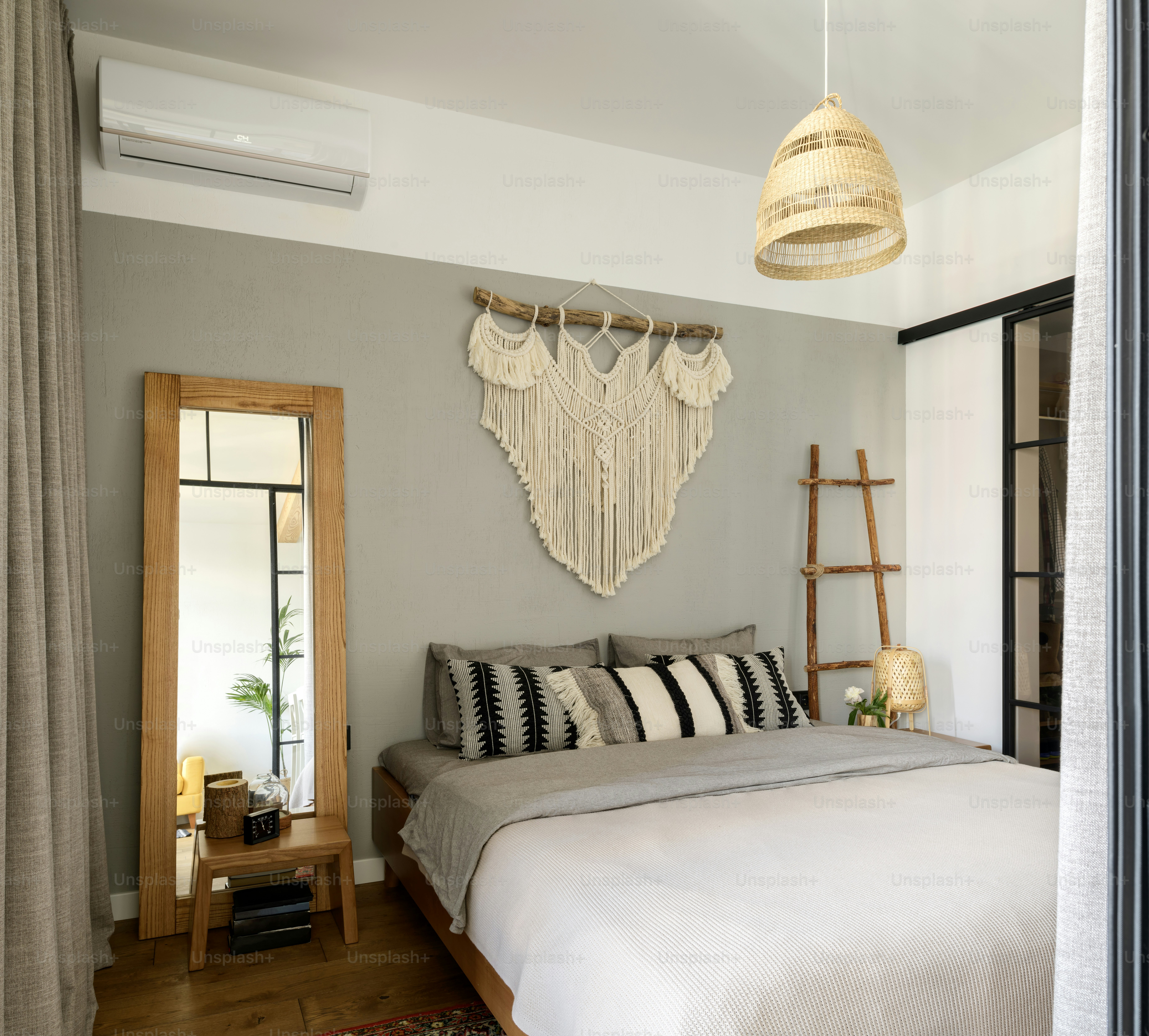 a bedroom with a large bed and a wooden ladder