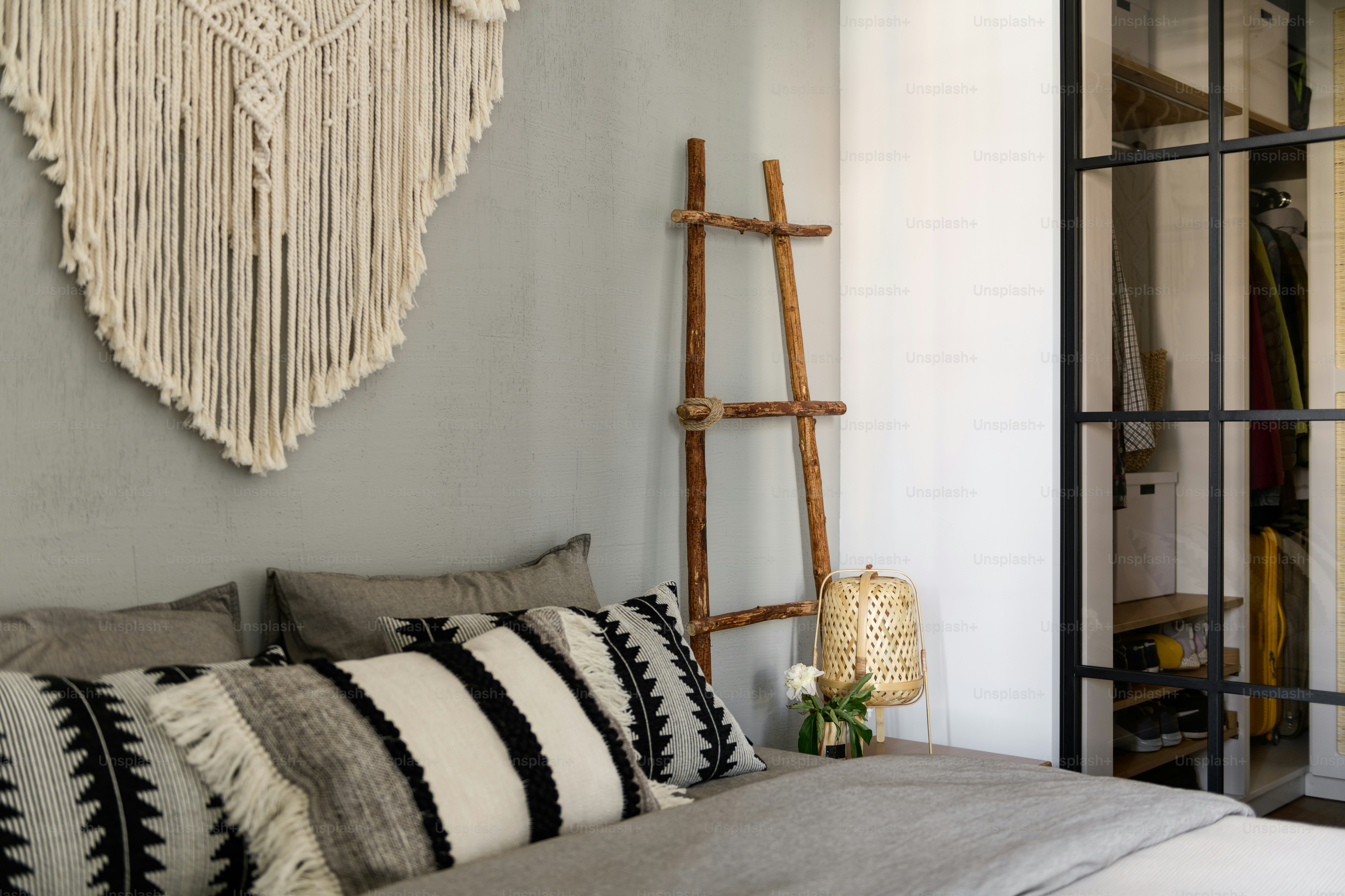 a bedroom with a bed and a wooden ladder