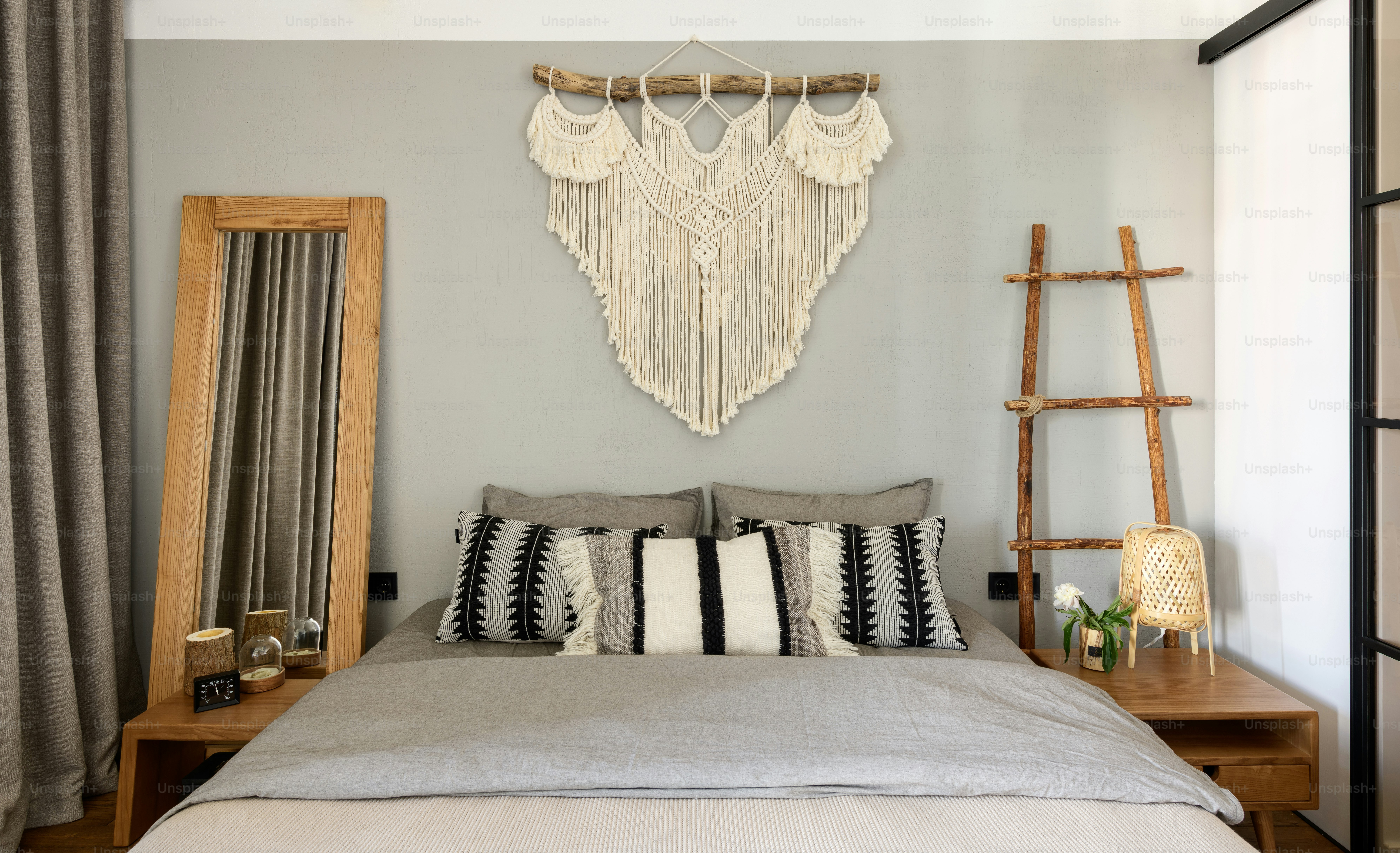 a bedroom with a large bed and a wall hanging