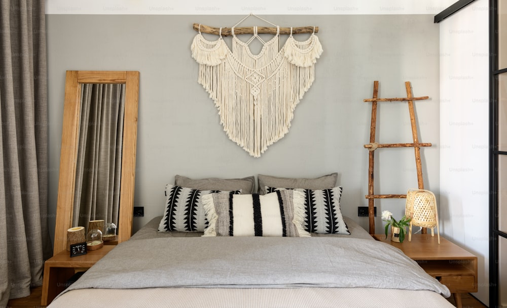 a bedroom with a large bed and a wall hanging