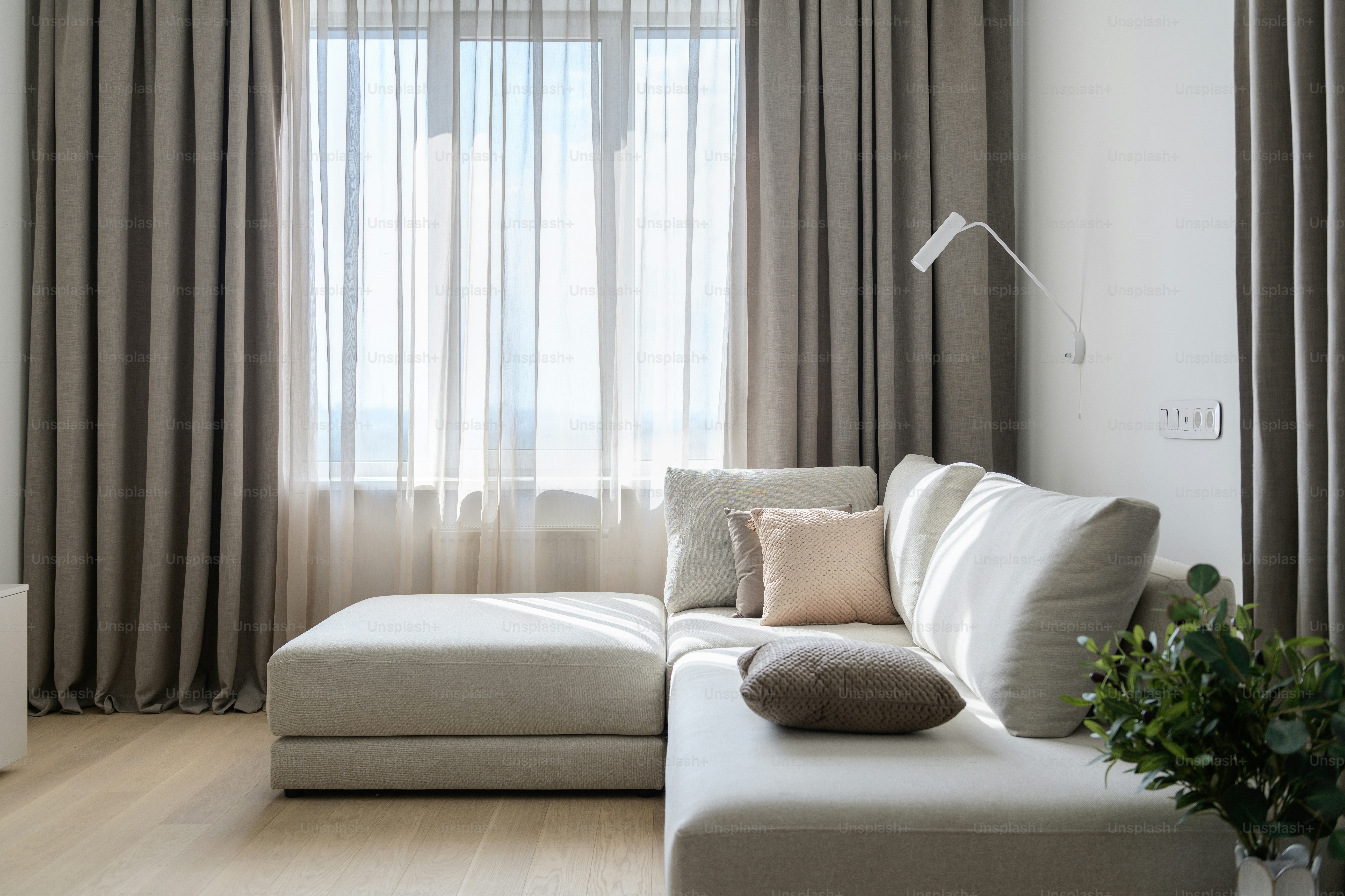 a living room with a white couch and a large window