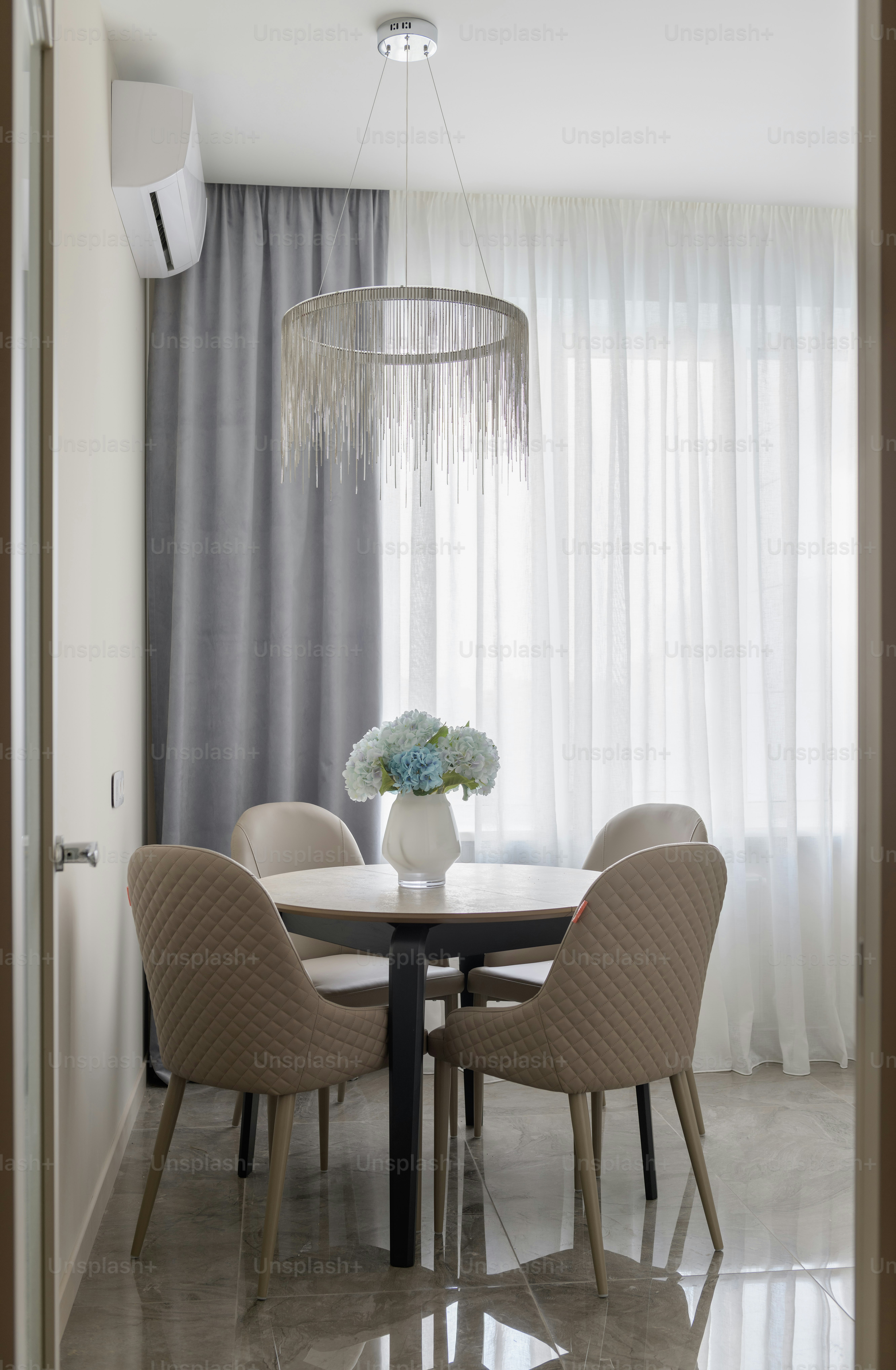 a dining room table with a vase of flowers on top of it
