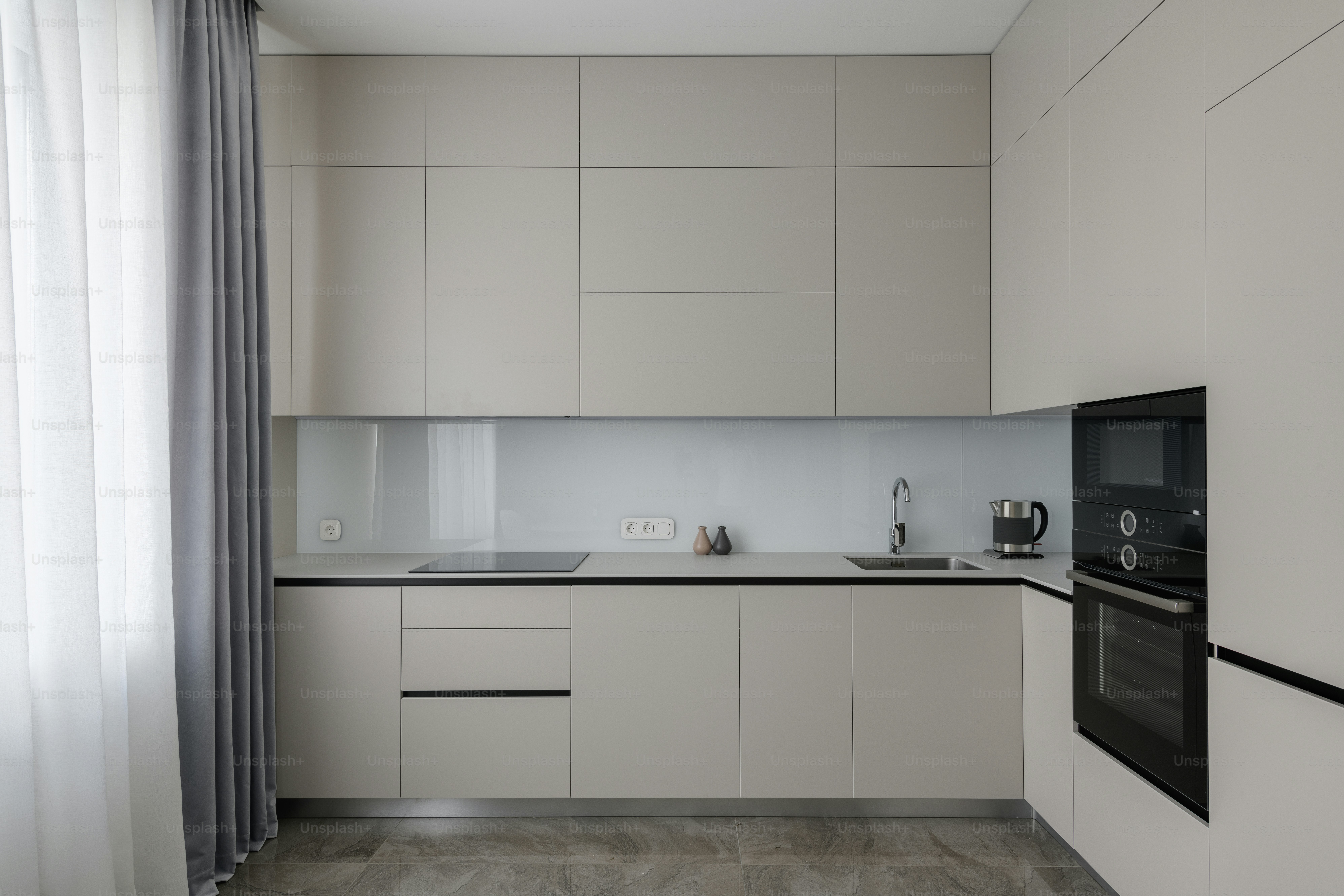 a kitchen with a stove, sink, and oven