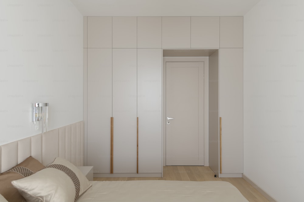 a bedroom with a bed and a white closet