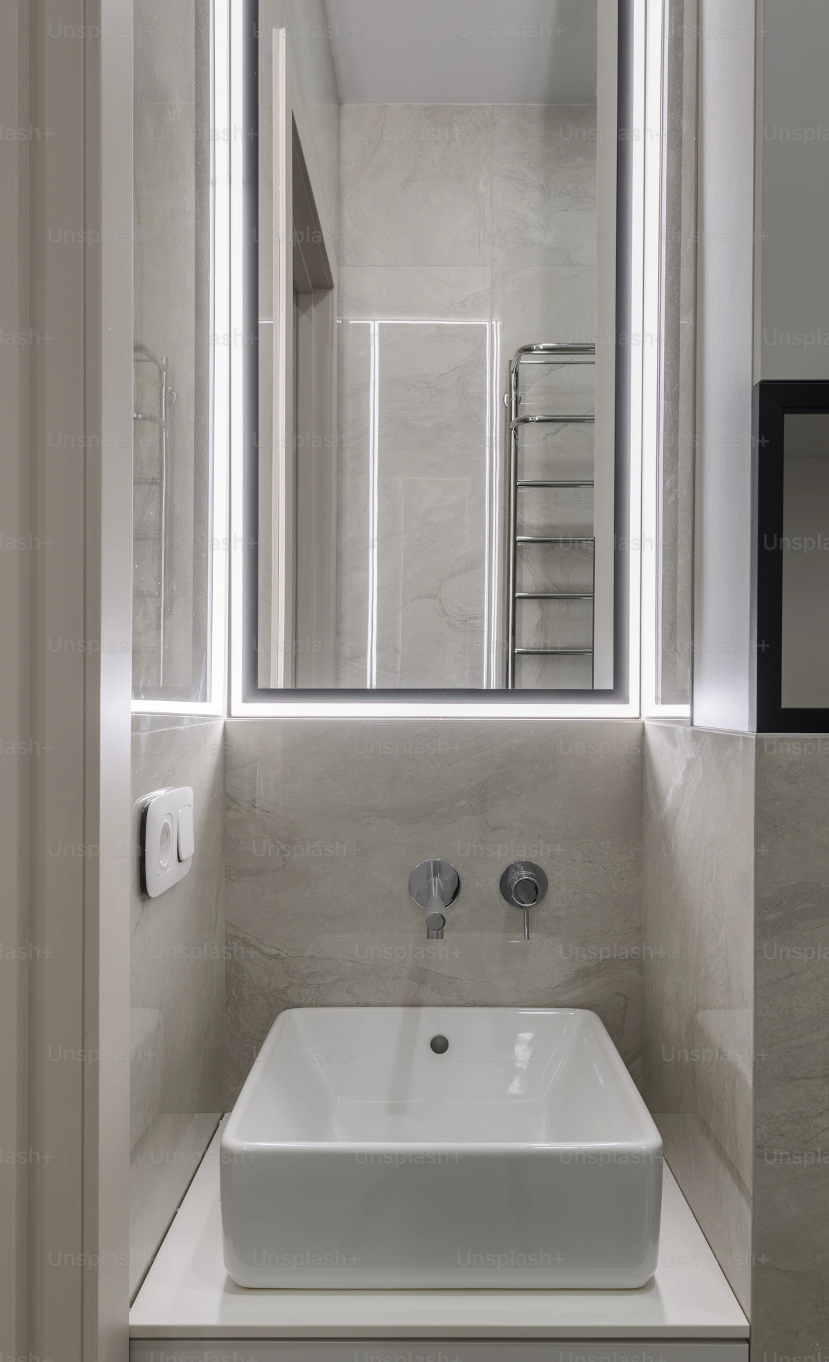 Finished bathroom renovation with new sink and mirror