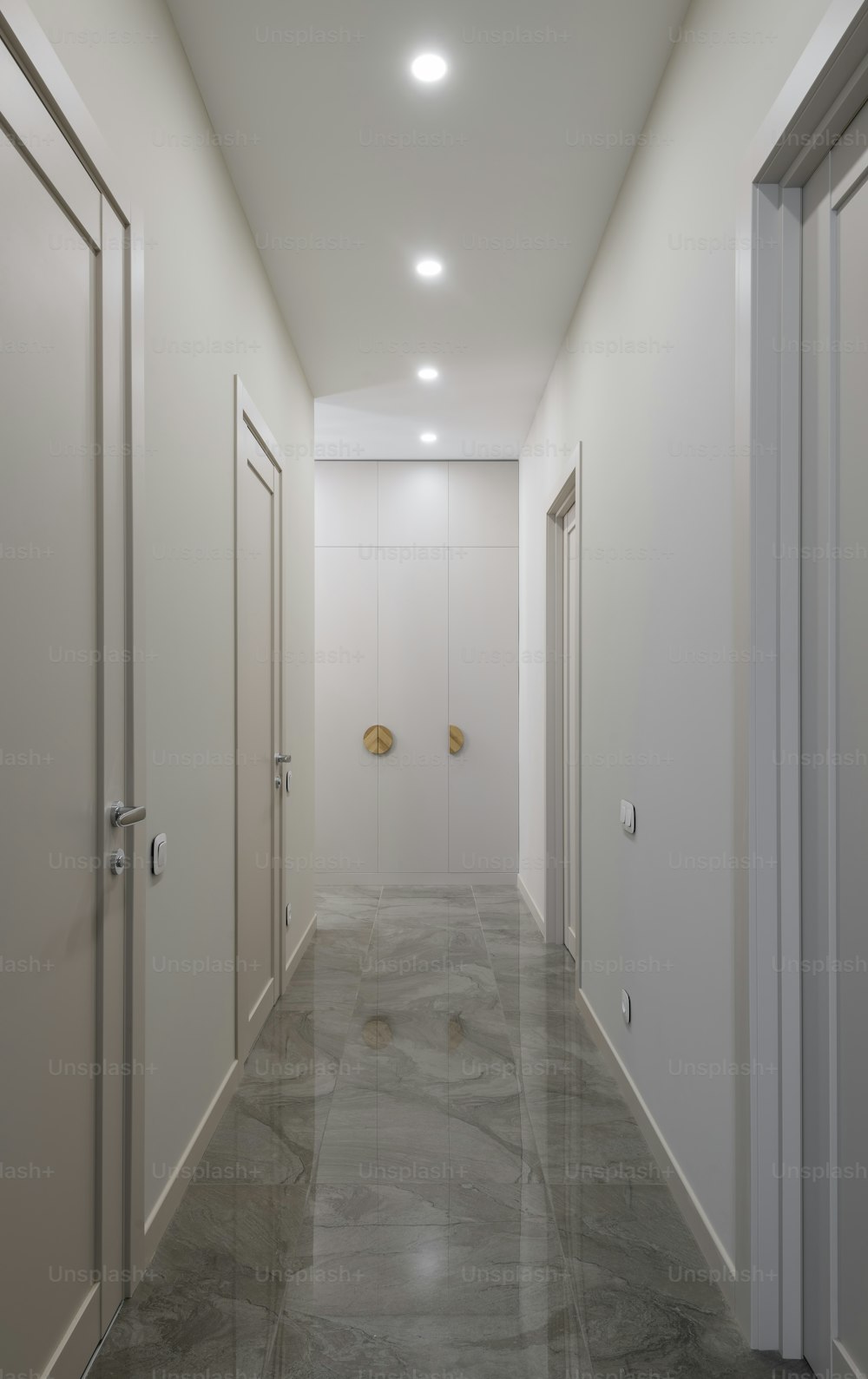 a long hallway with white walls and doors