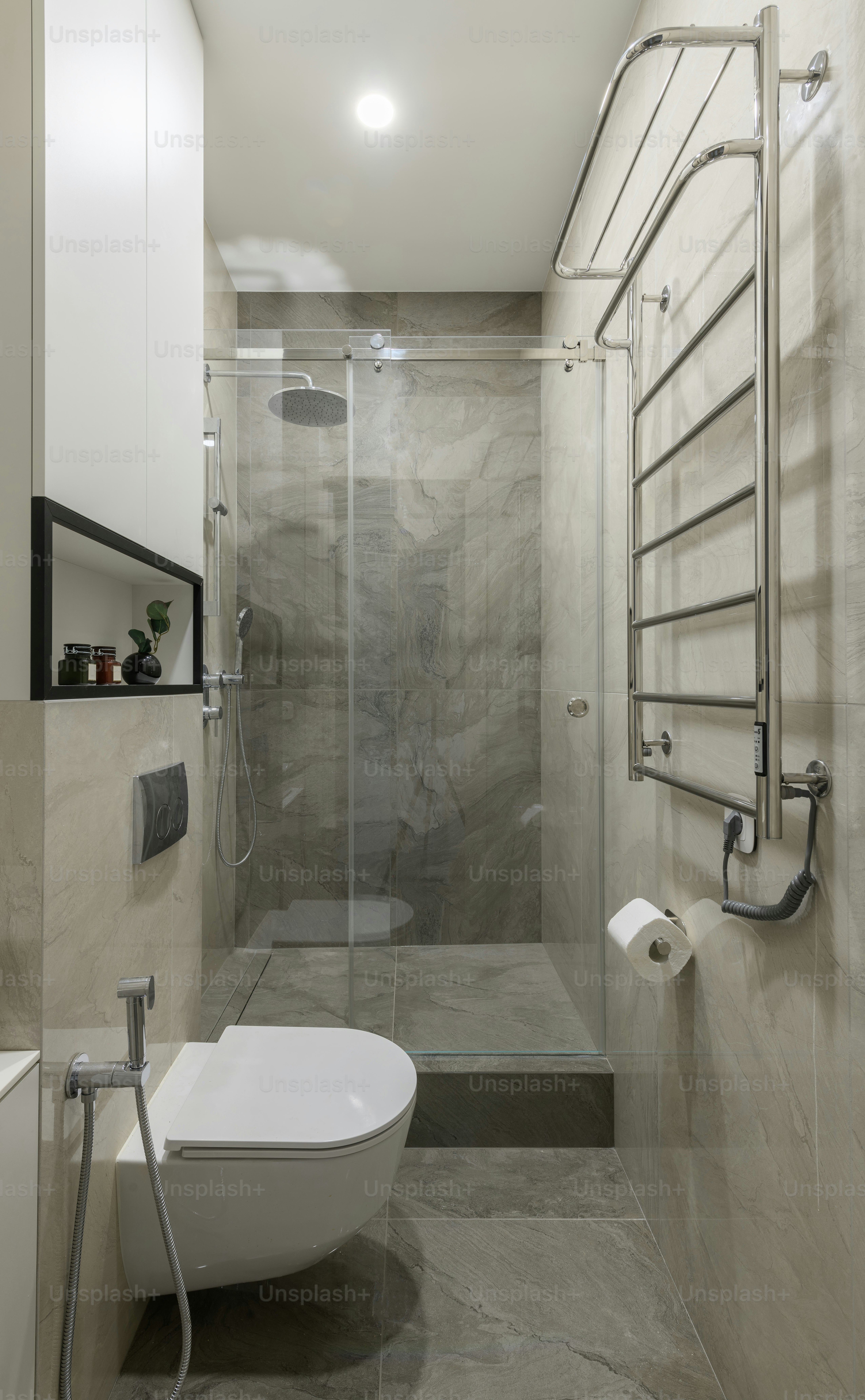 a bathroom with a toilet, shower, and sink