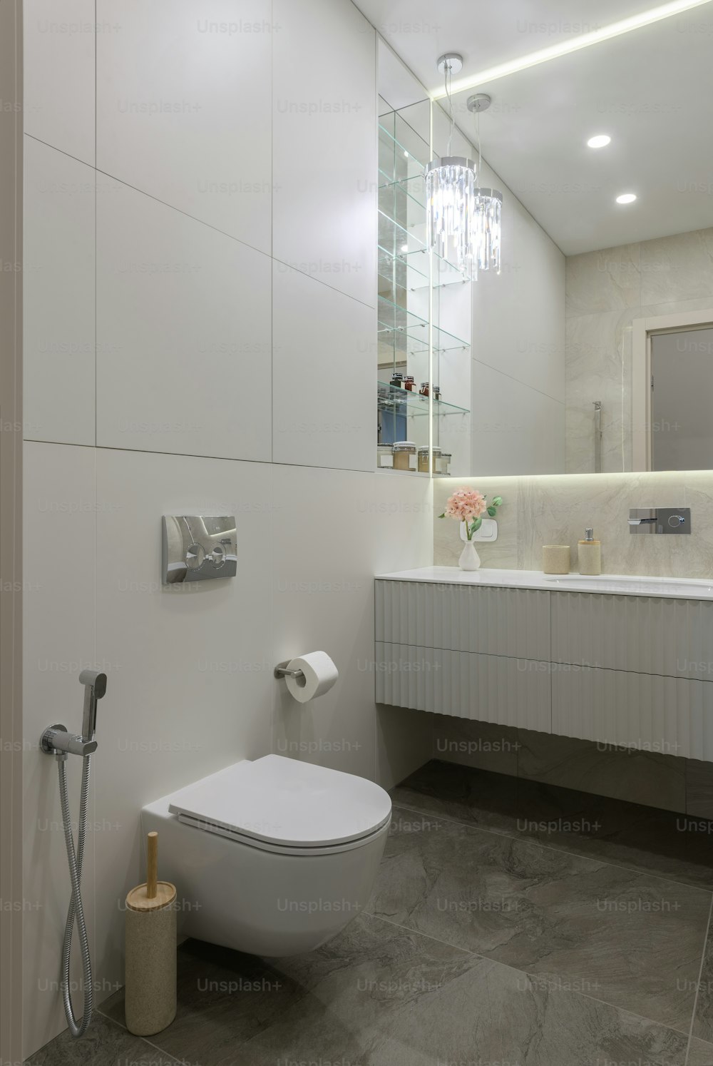 a bathroom with a toilet, sink, and mirror