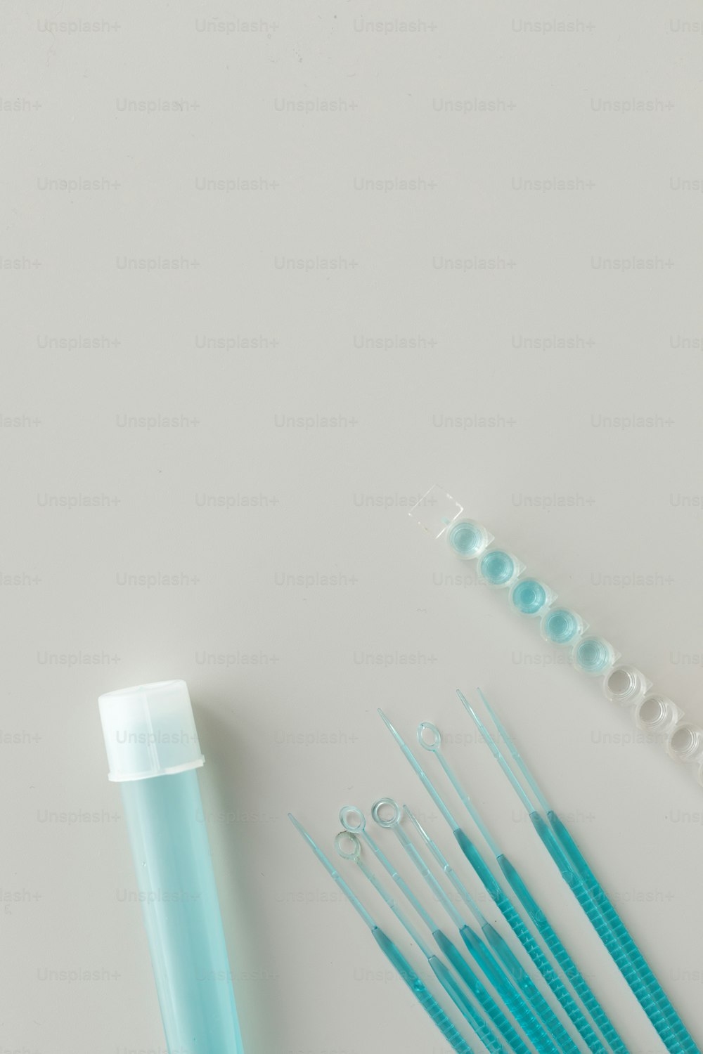 a group of blue toothbrushes sitting next to a tube of toothpaste