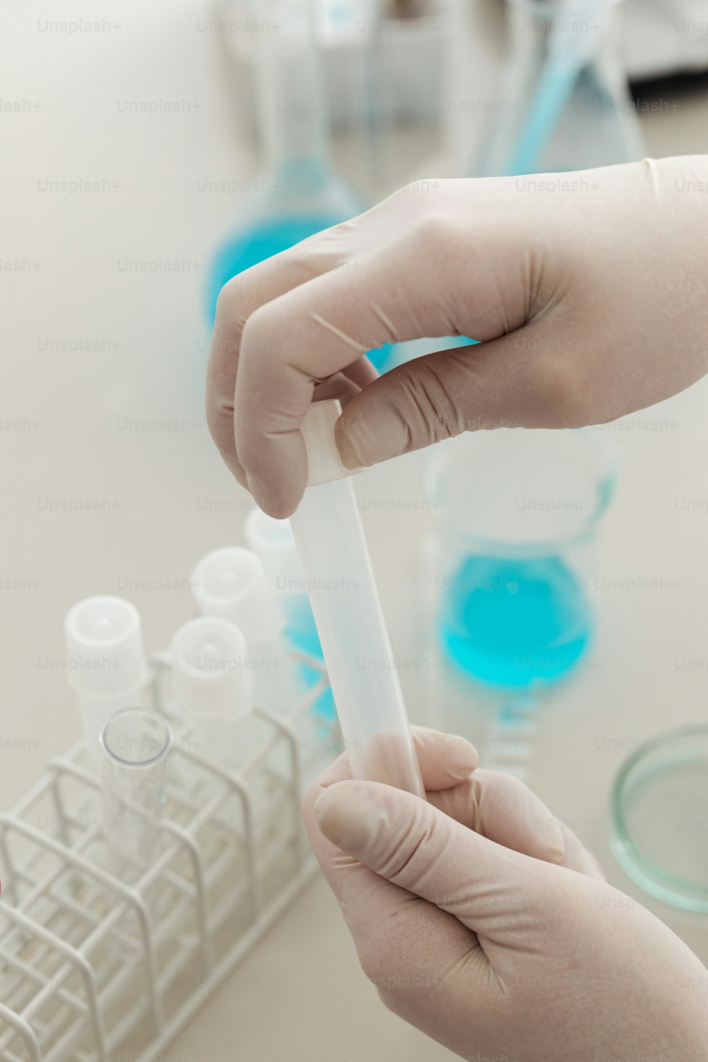 a person holding a tube of liquid in their hand