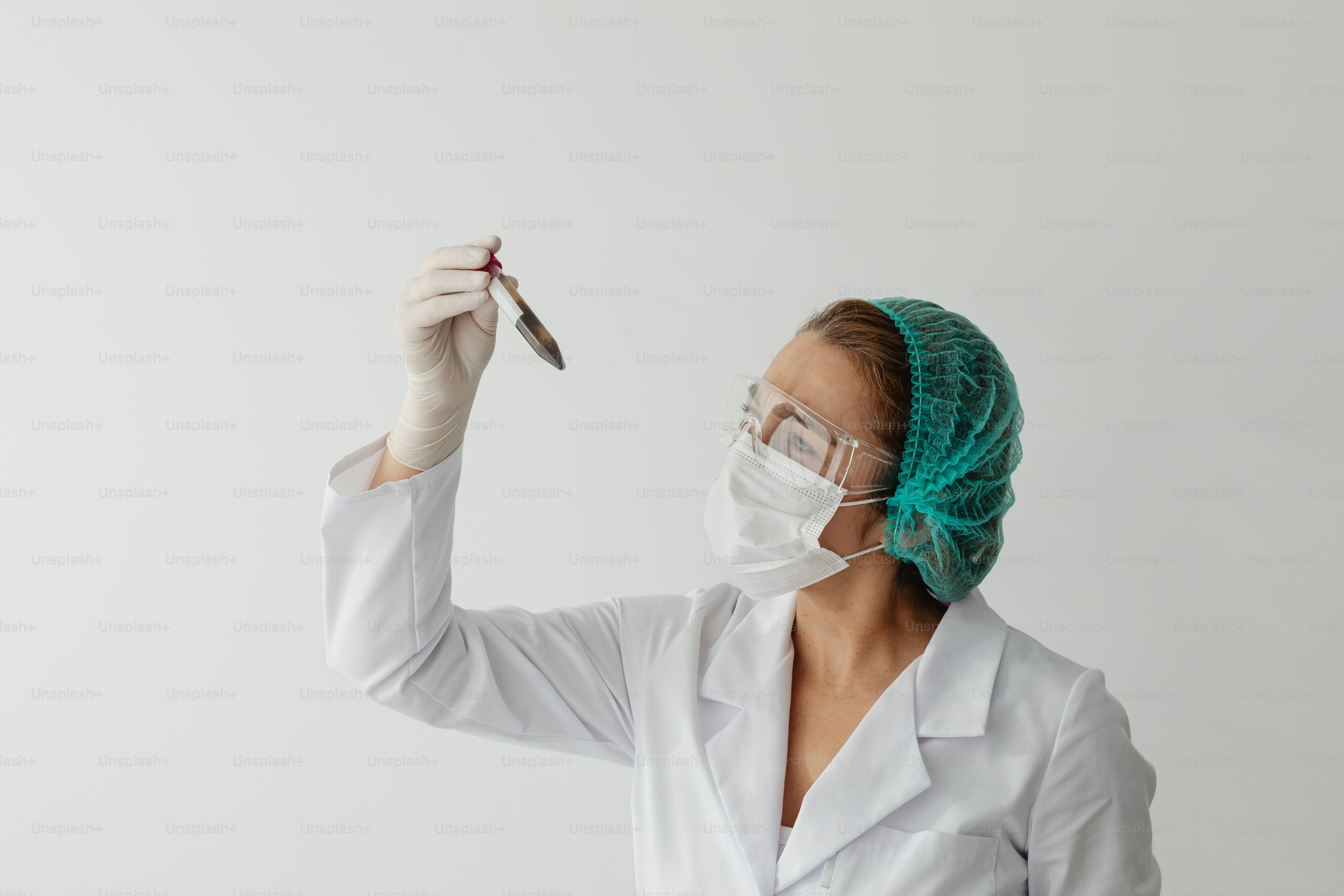 A woman in a white lab coat holding a pair of scissors photo Laboratory Image on Unsplash