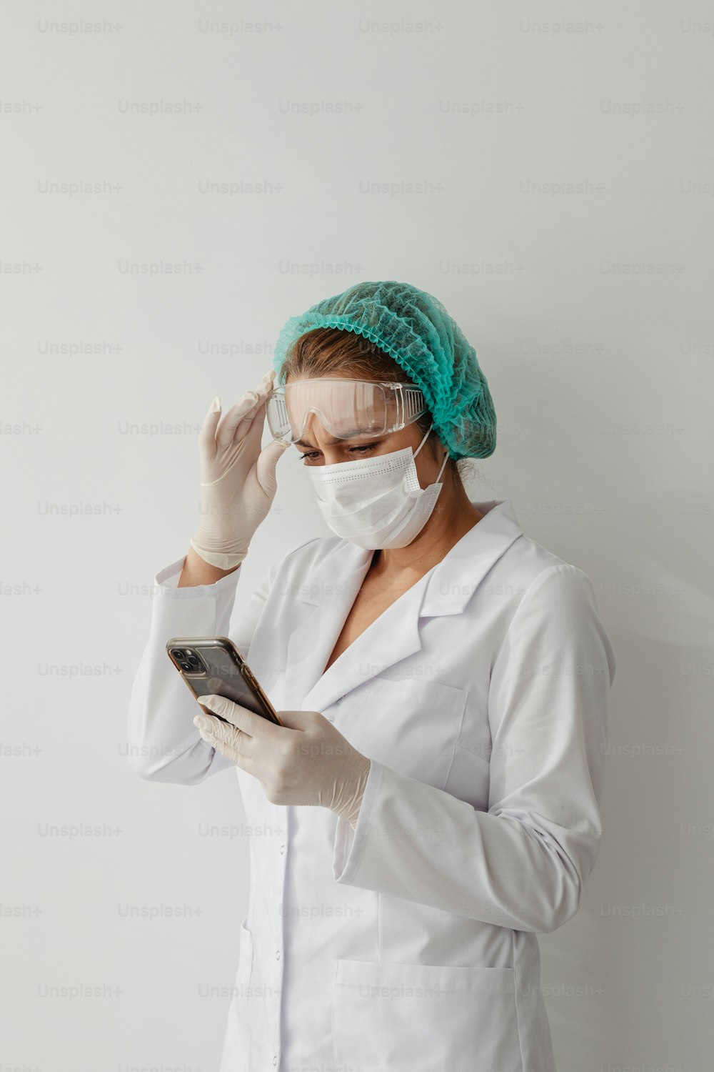 a woman wearing a surgical mask and holding a cell phone