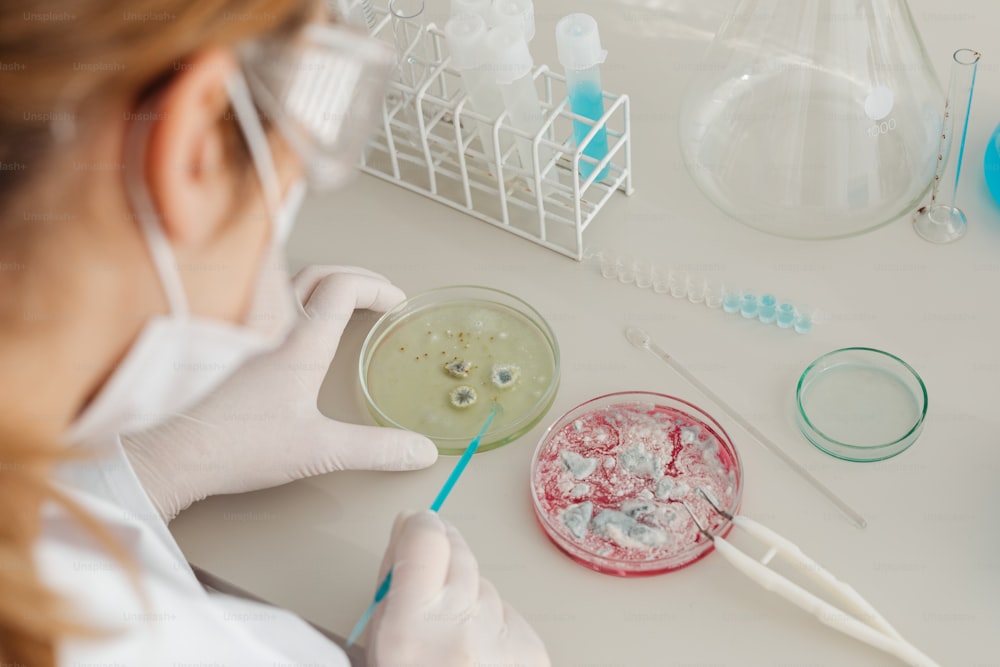 a woman in a white lab coat holding a spoon