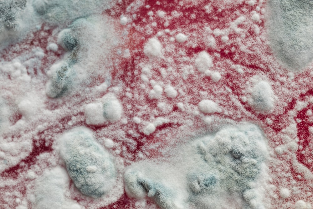 a close up of snow on a red surface