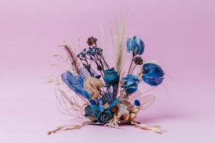 a bouquet of blue flowers on a pink background