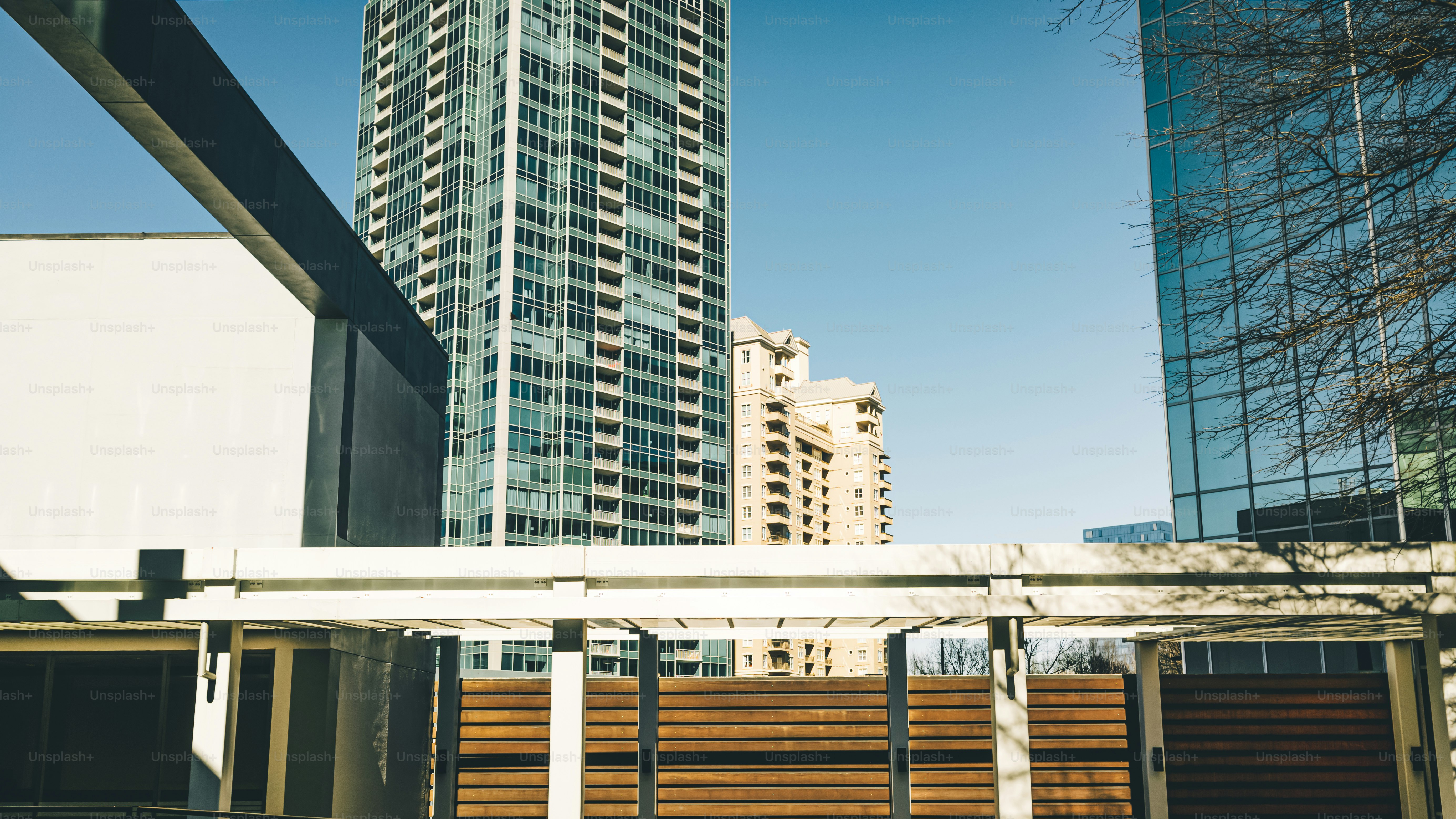 a tall building in the background with a fence in the foreground