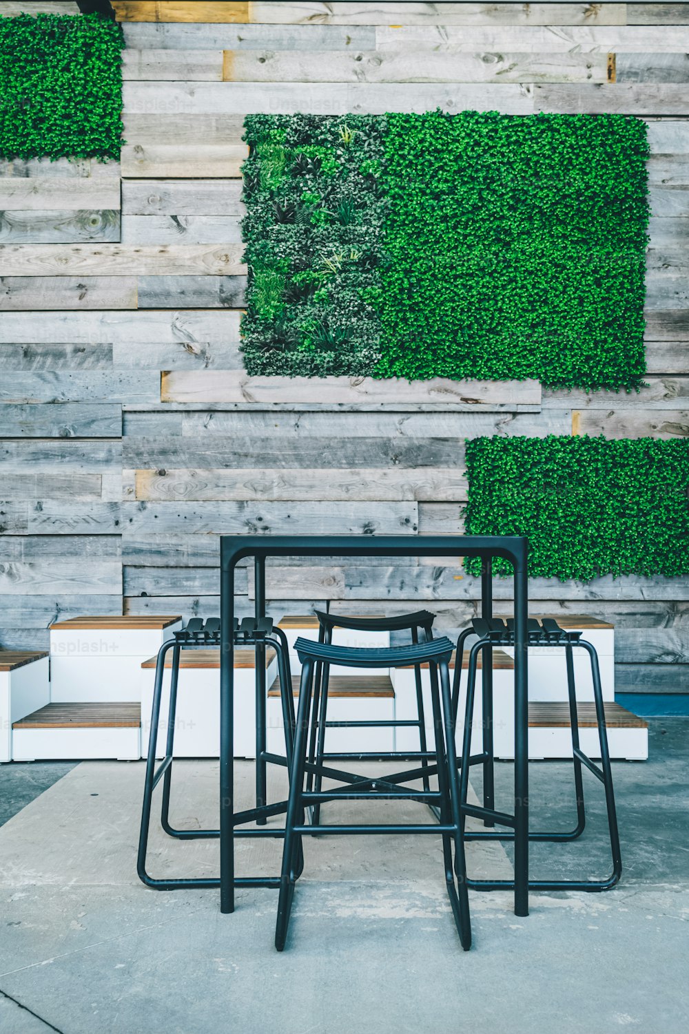 a group of chairs sitting in front of a wooden wall