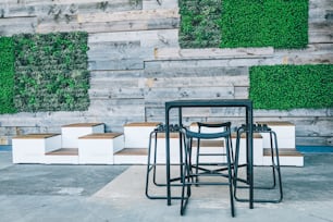 a set of four stools sitting in front of a wooden wall