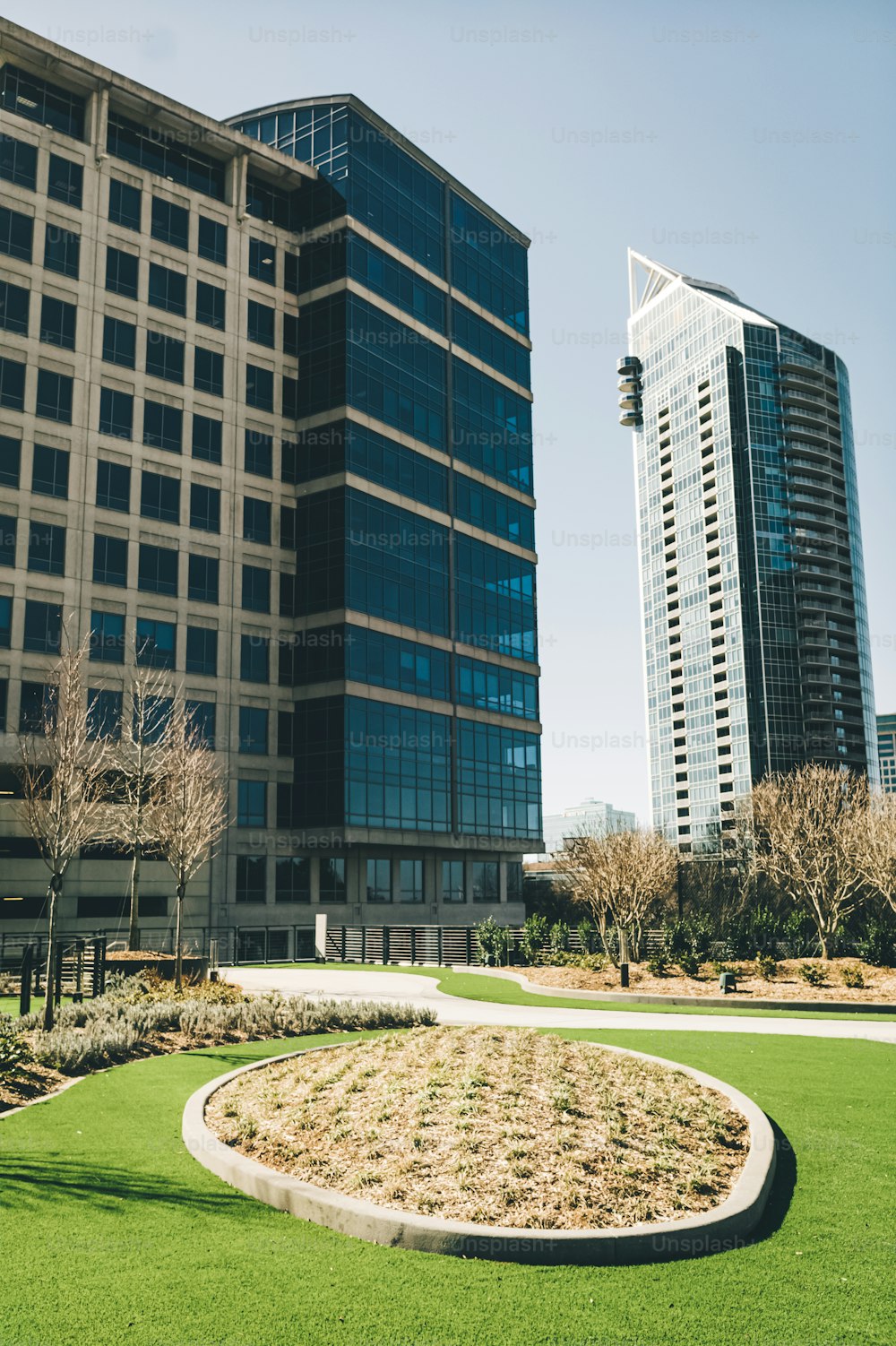 a grassy area in front of two tall buildings