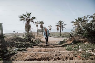 a woman walking down a set of stairs